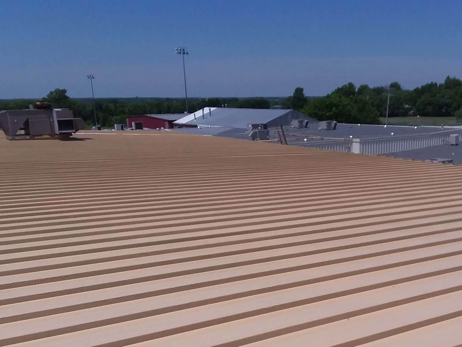 Cleaned and coated commercial metal roof ready for restoration